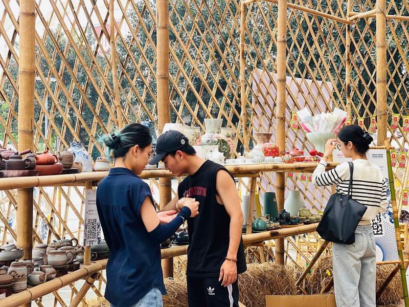 Phía bên khu vực gốm Bát Tràng cũng thu hút đông đảo khách tham quan. Nổi tiếng với kỹ thuật nung và tạo hình tinh xảo, gốm Bát Tràng không chỉ bền đẹp mà còn mang đậm dấu ấn văn hóa Việt. Tại đây, nhiều sản phẩm đa dạng được trưng bày như bát, đĩa, ấm chén, lọ hoa, tượng trang trí và các món đồ thủ công mỹ nghệ. Mỗi sản phẩm đều thể hiện sự khéo léo của người nghệ nhân, kết hợp giữa giá trị truyền thống và tính ứng dụng trong đời sống. Ảnh: Mai Linh